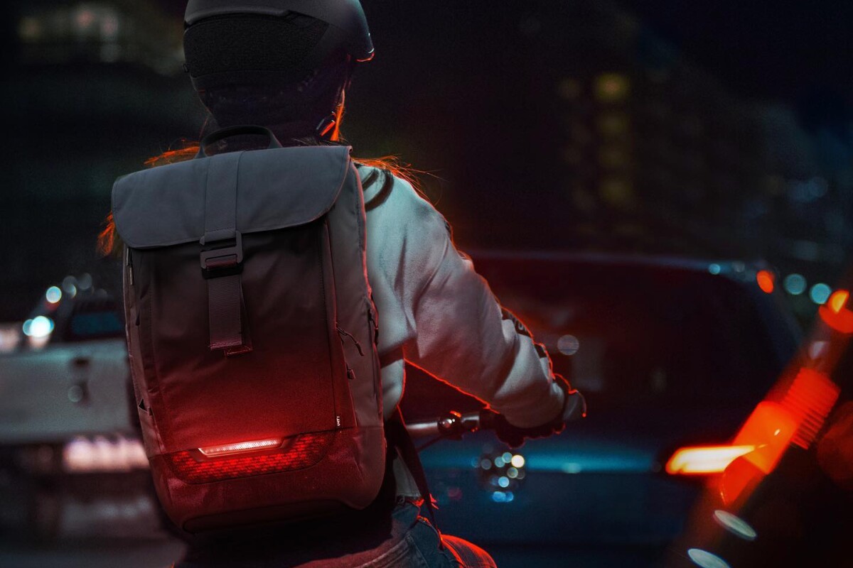 Torch cycling backpack sports its own tail light and turn indicators